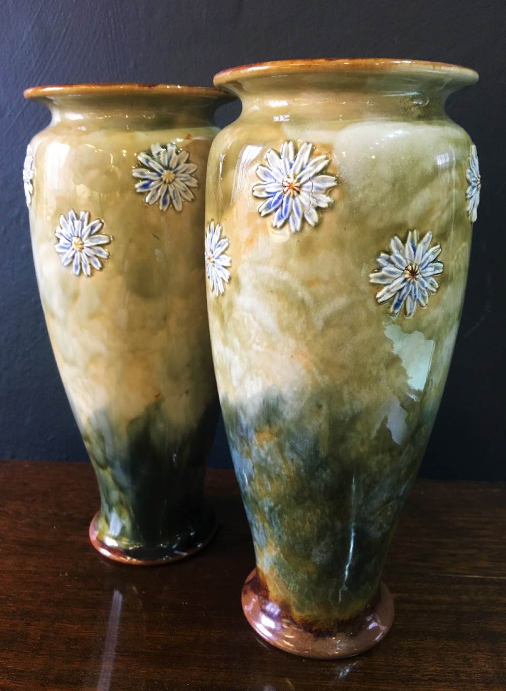 emily welch royal doulton vases with flowerheads on green ground c1902