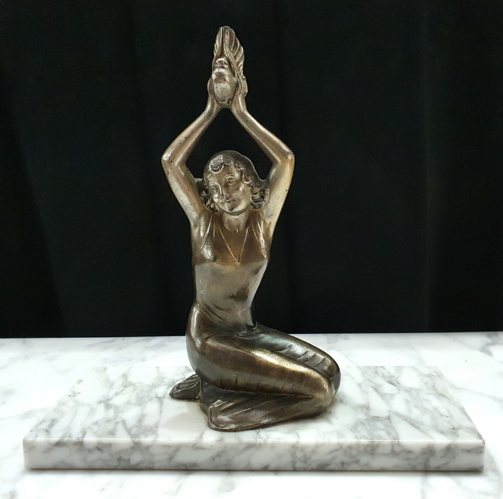 french art deco message of love sculpture of young woman holding dove on marble plinth